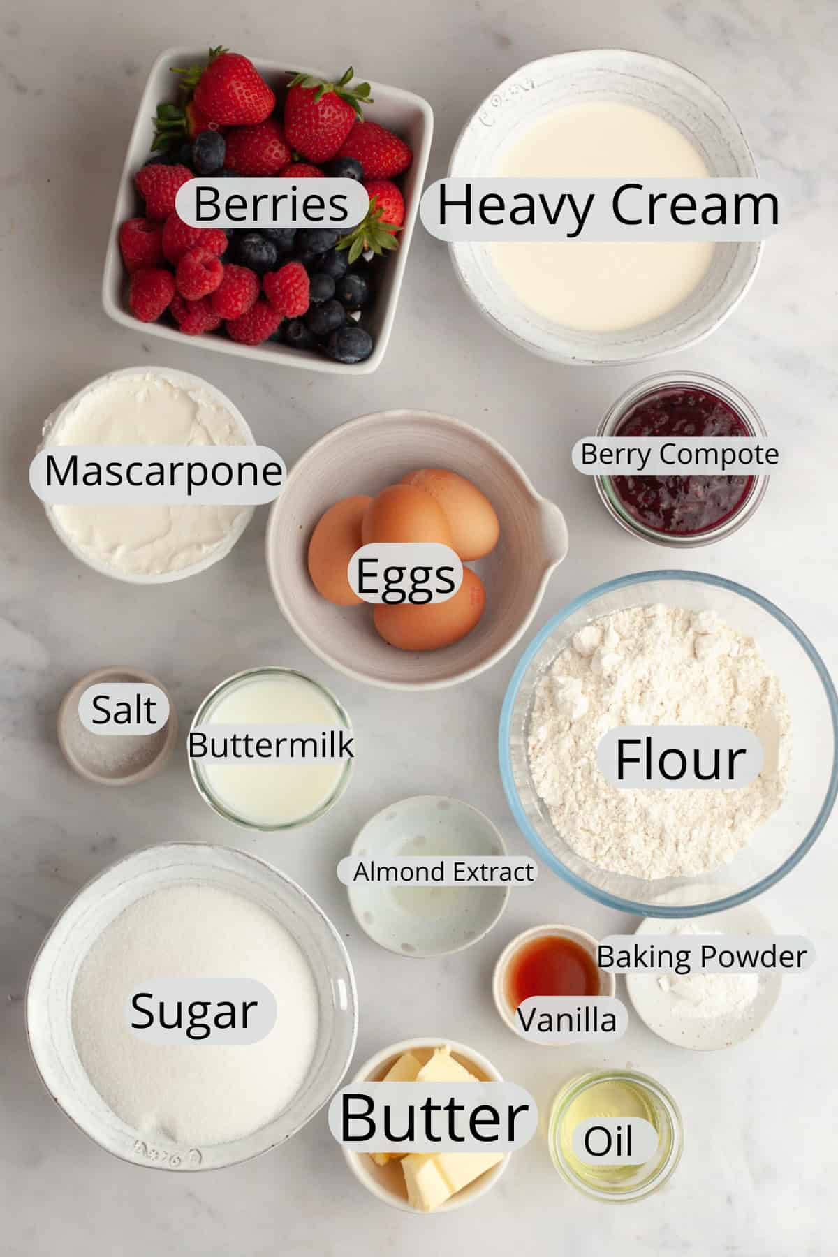 All the ingredients needed to make a berry vanilla cake, weighed out into small bowls.