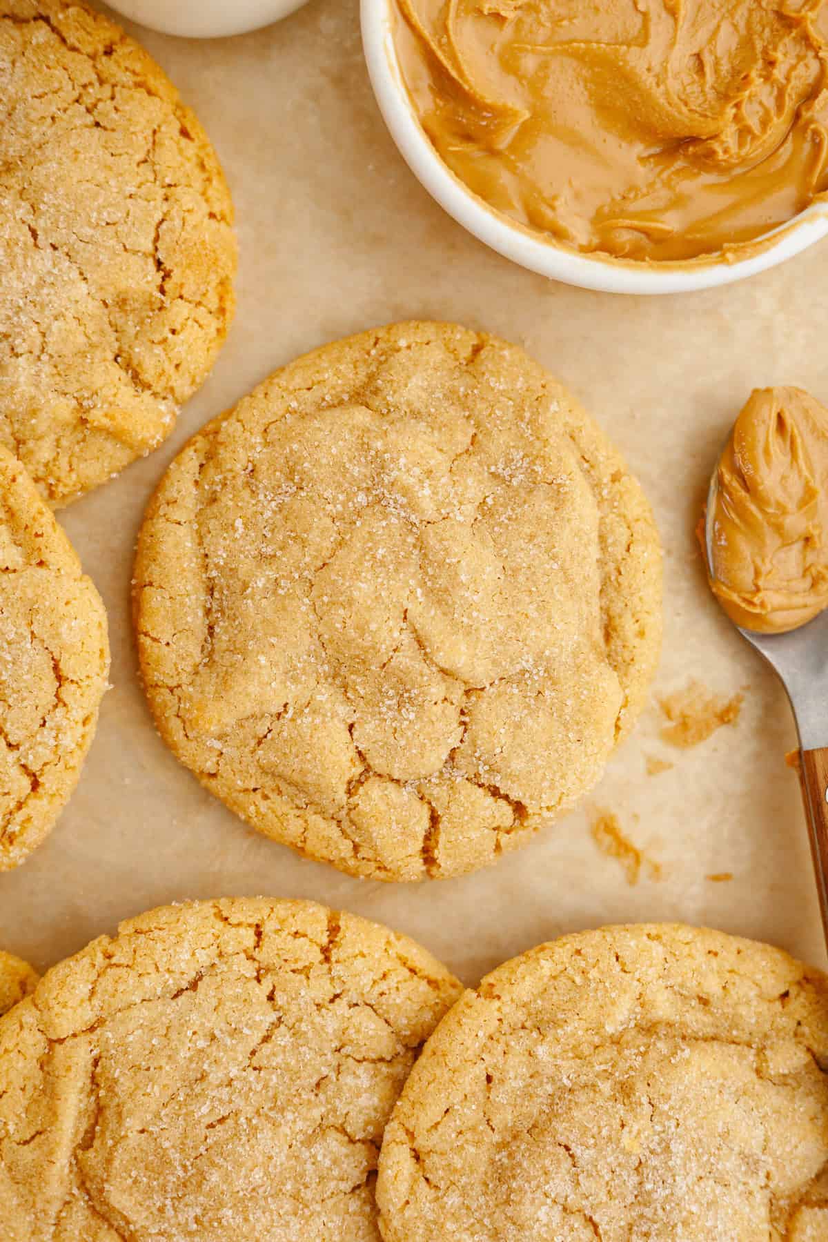 Peanut butter cookies with brown butter on brown parchment paper.
