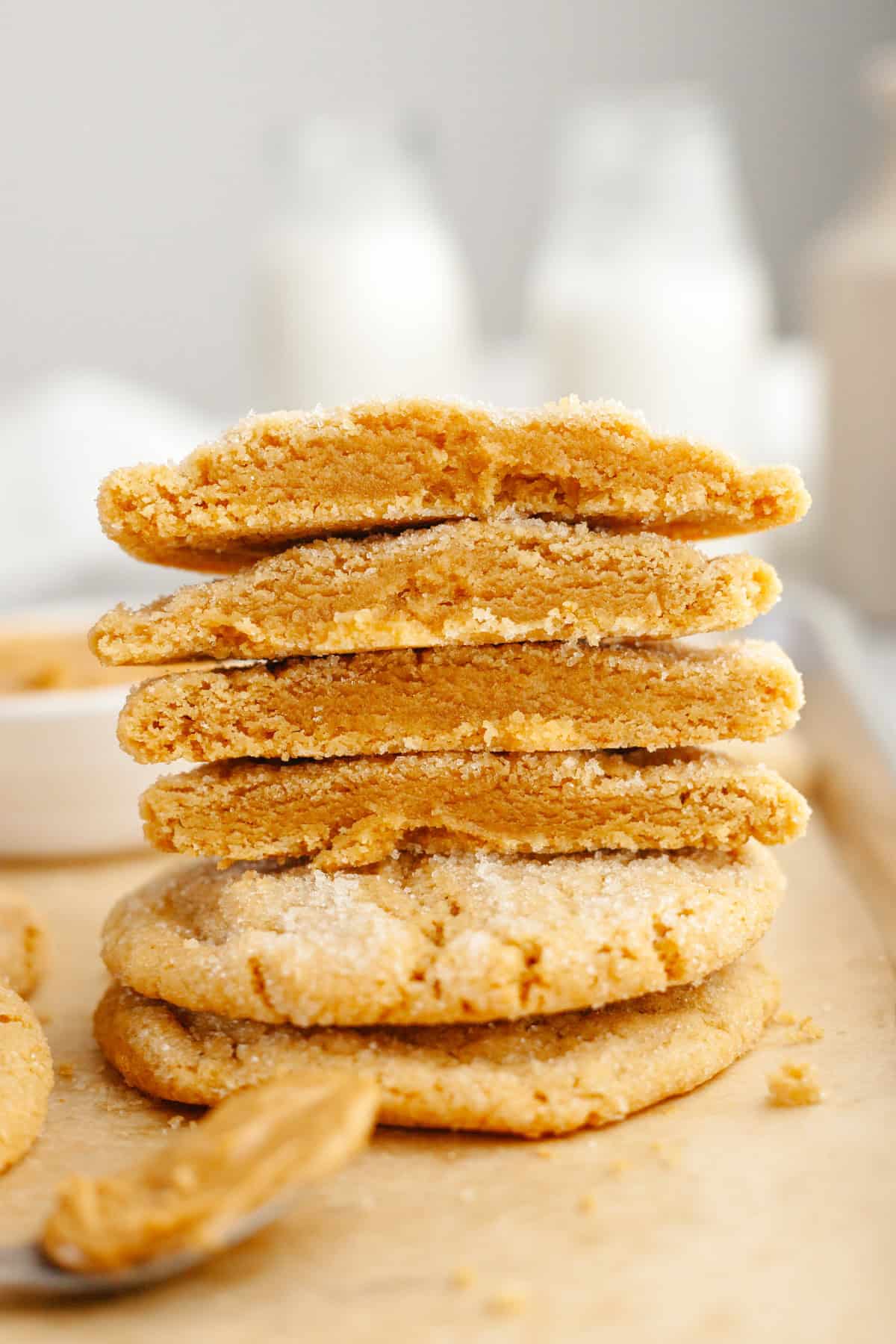 A stack of peanut butter cookies cut in half.