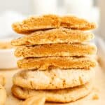 A stack of browned butter peanut butter cookies cut in half.