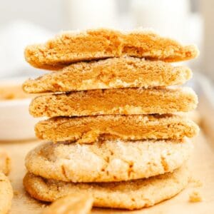 A stack of browned butter peanut butter cookies cut in half.