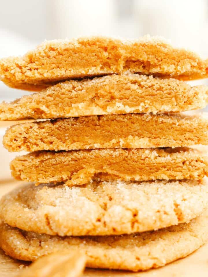 A stack of browned butter peanut butter cookies cut in half.