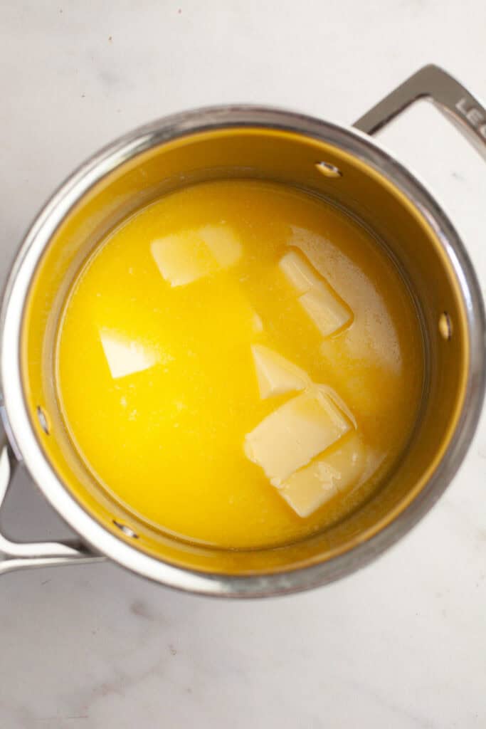 A saucepan with melting butter in it.
