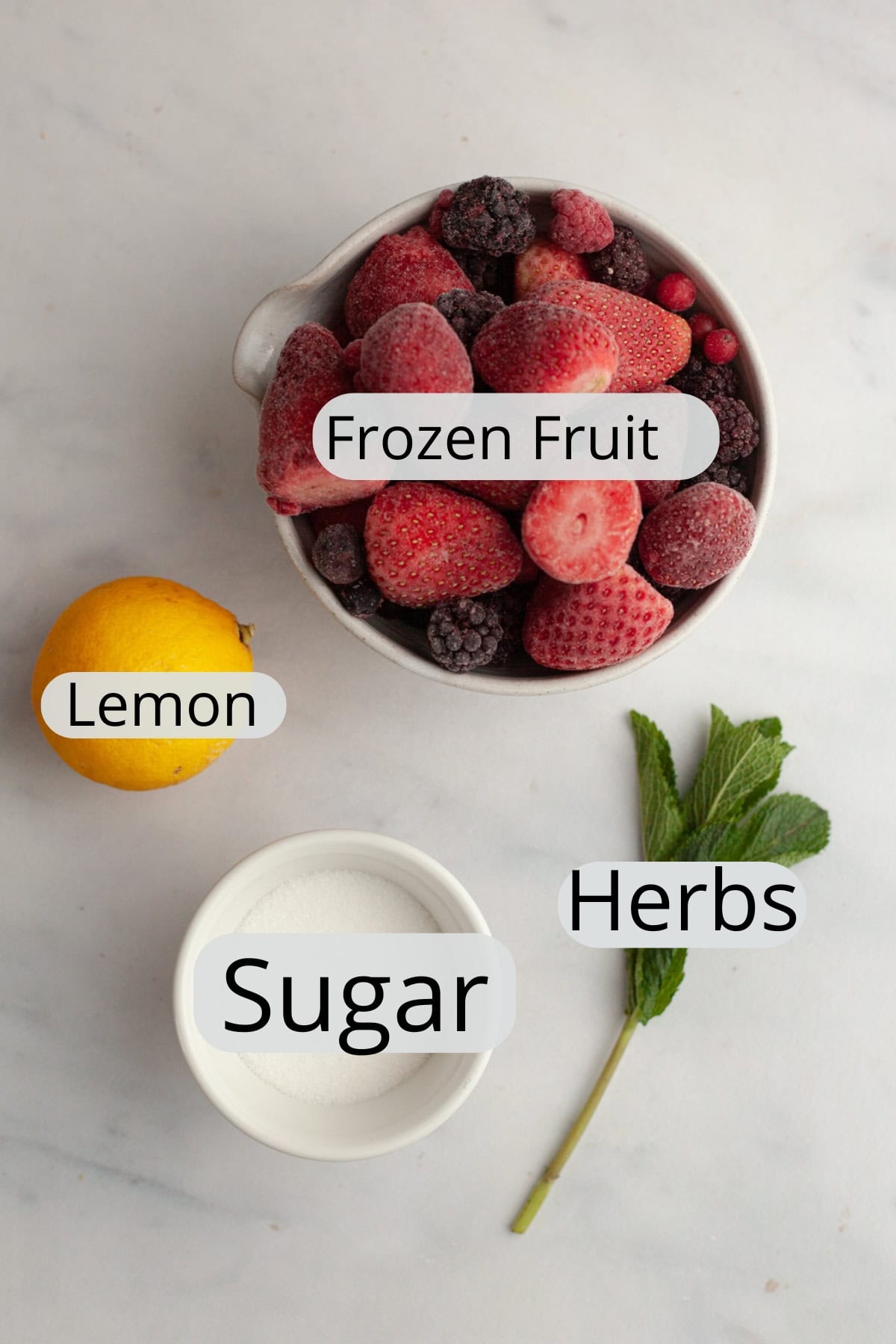 All the ingredients needed to make mixed berry compote, weighed out into small bowls.