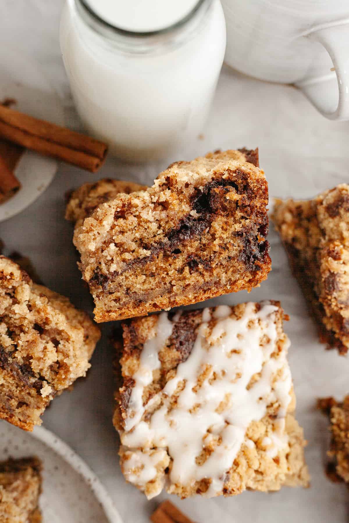 Square slices of banana coffee cake, some slices are drizzled with a white glaze.