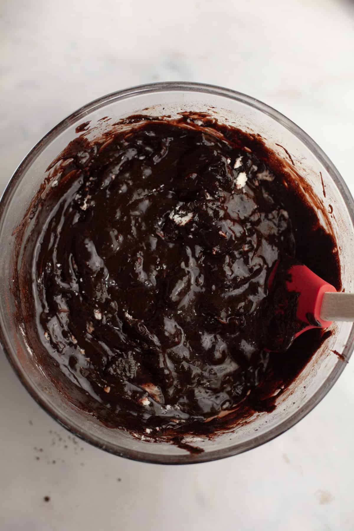 A large bowl with brownie batter and chopped Oreos.