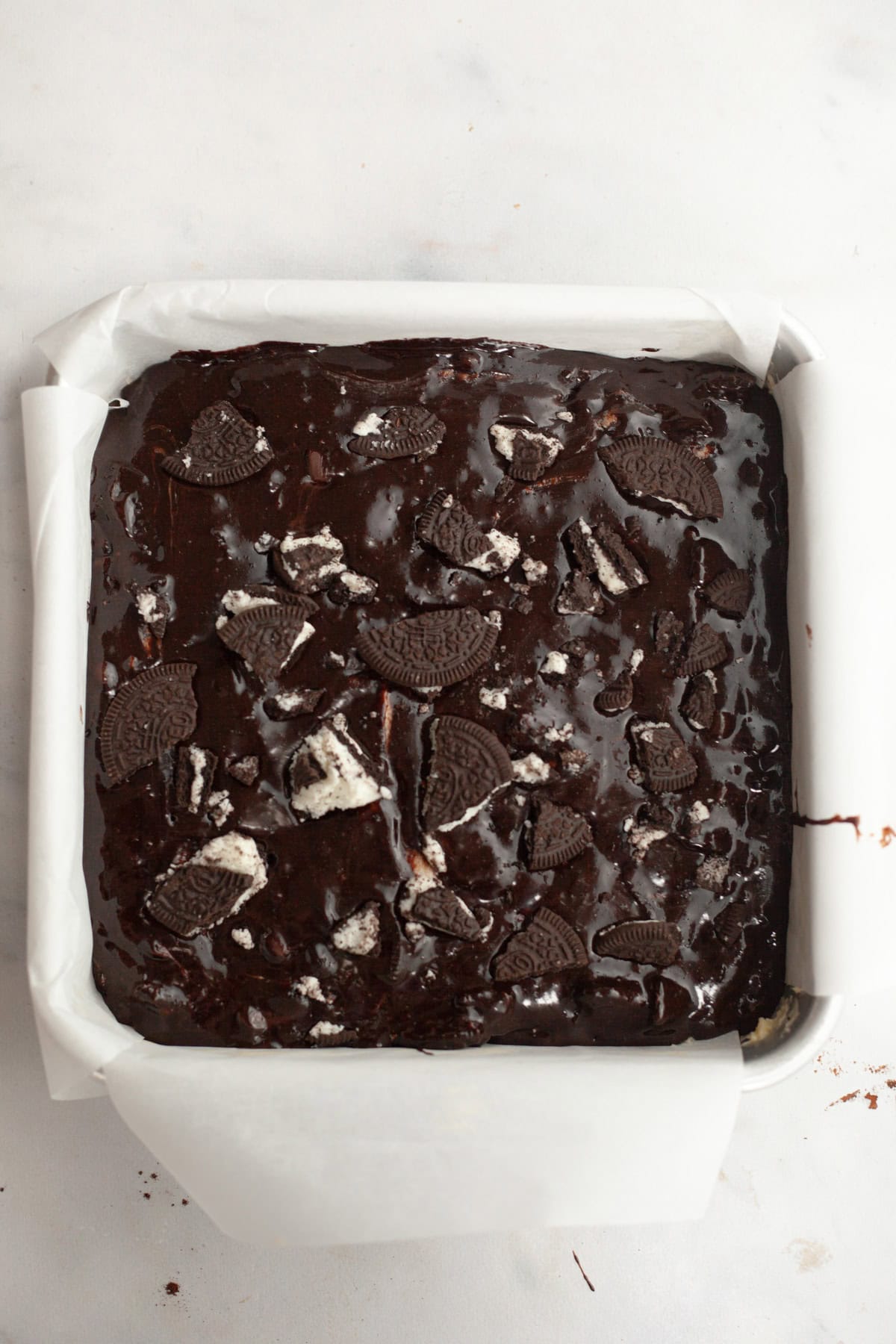 Unbaked Oreo brownies in a square baking pan.