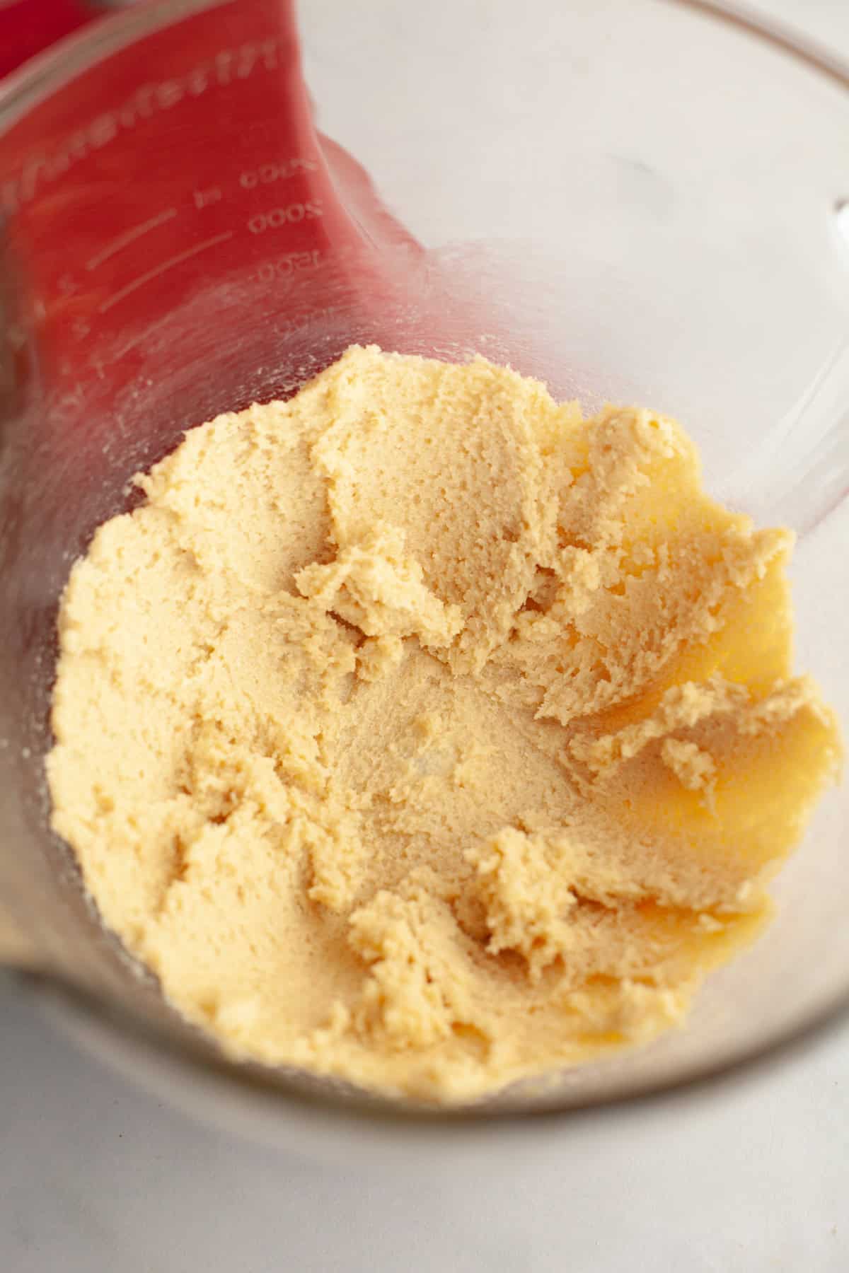 Creamed butter and sugar in a glass bowl.