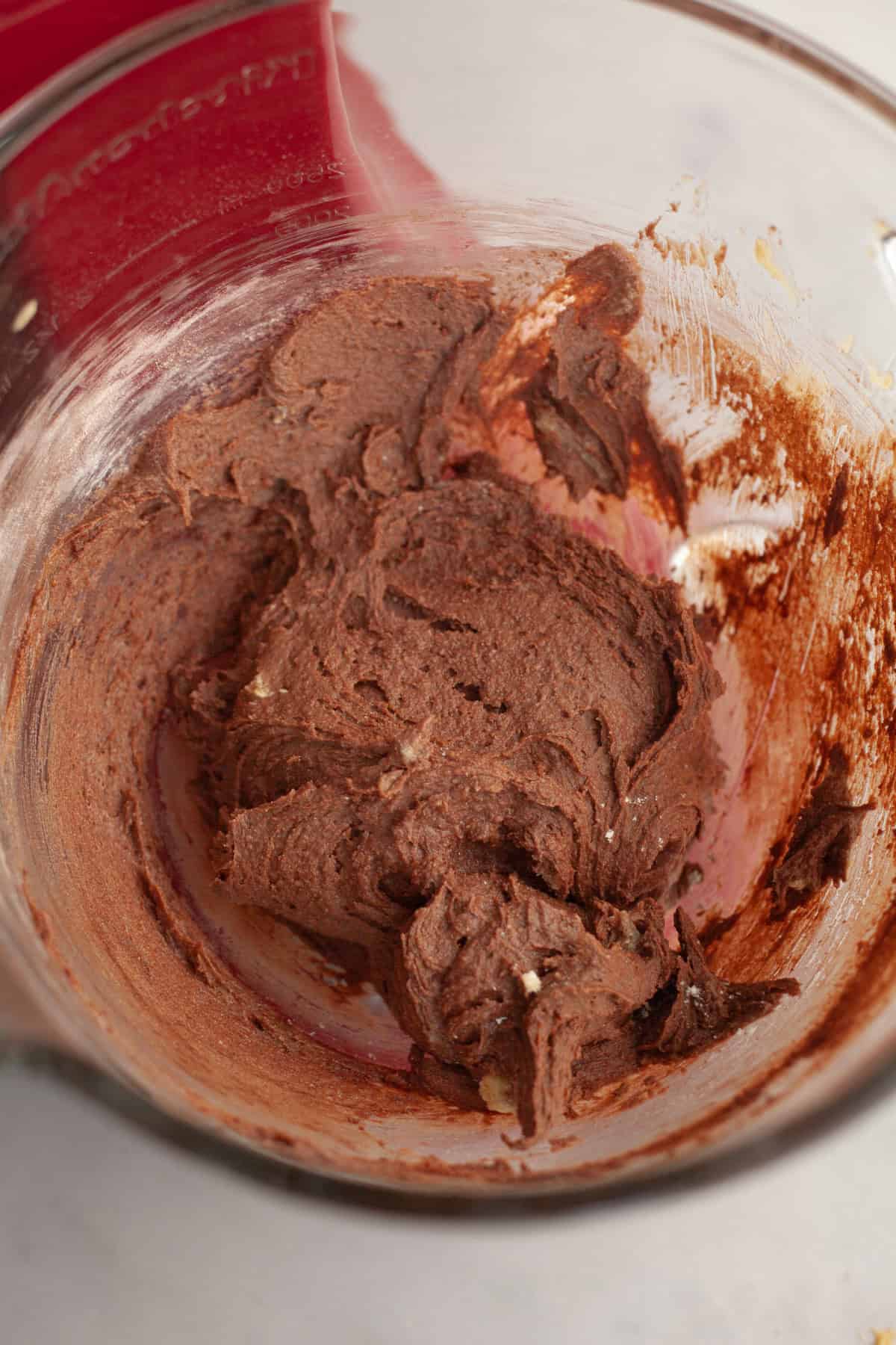 Chocolate cookie dough in a glass bowl.