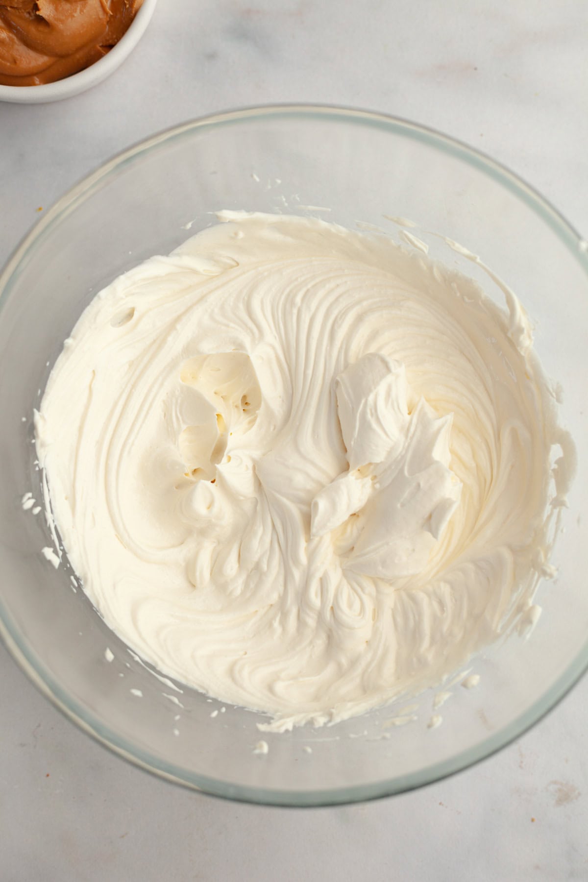 Whipped cream in a glass bowl.