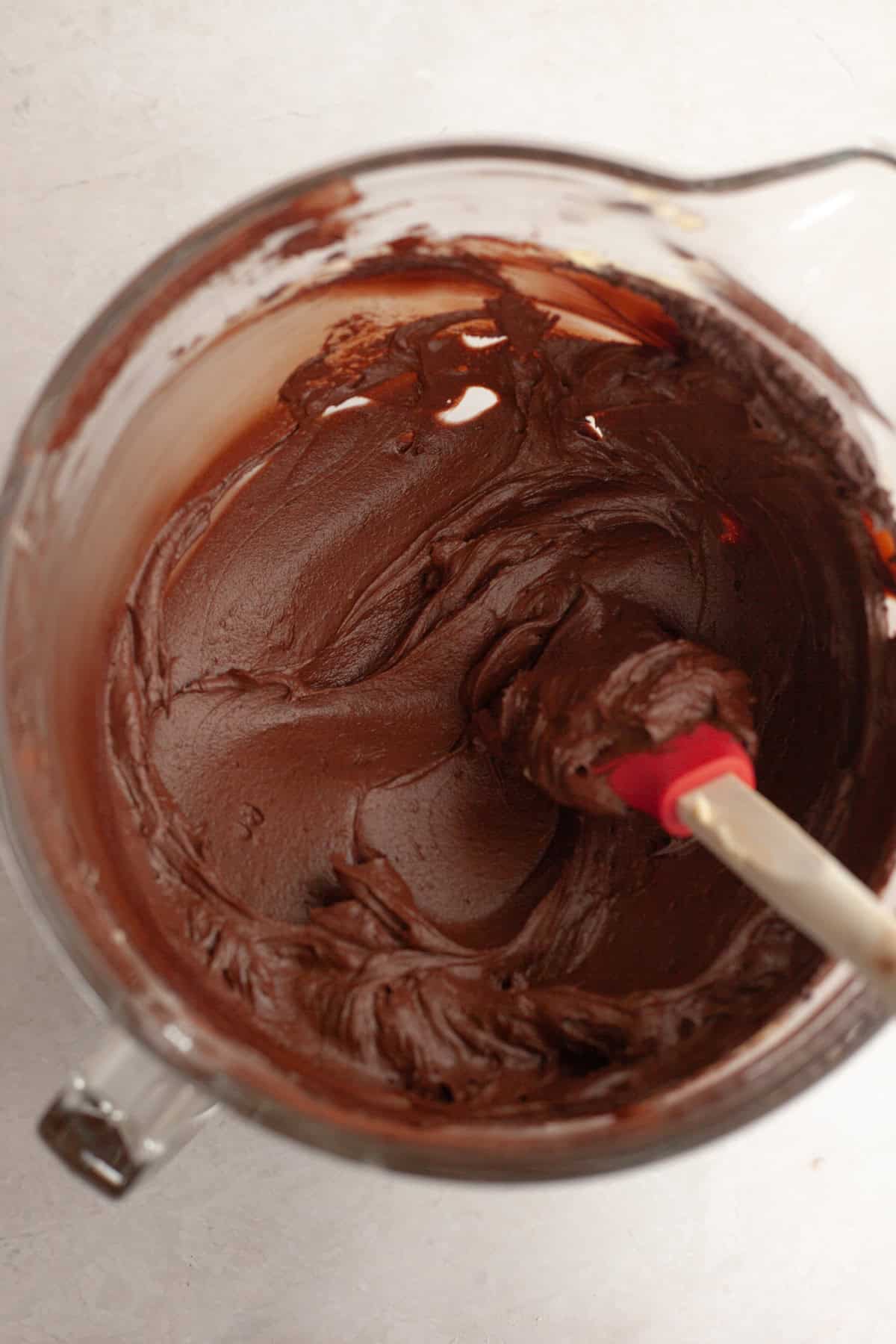 Chocolate fudge frosting in a large glass bowl.
