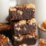 A stack of three fudgy walnut brownies.