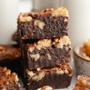 A stack of three fudgy walnut brownies.