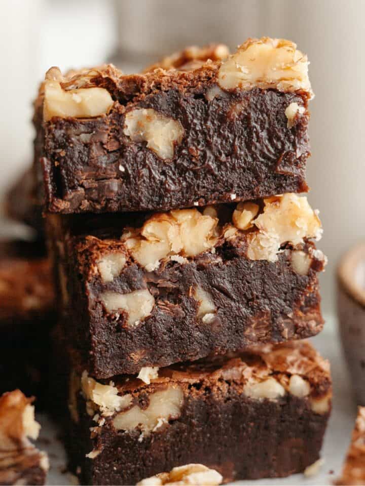 A stack of three fudgy walnut brownies.