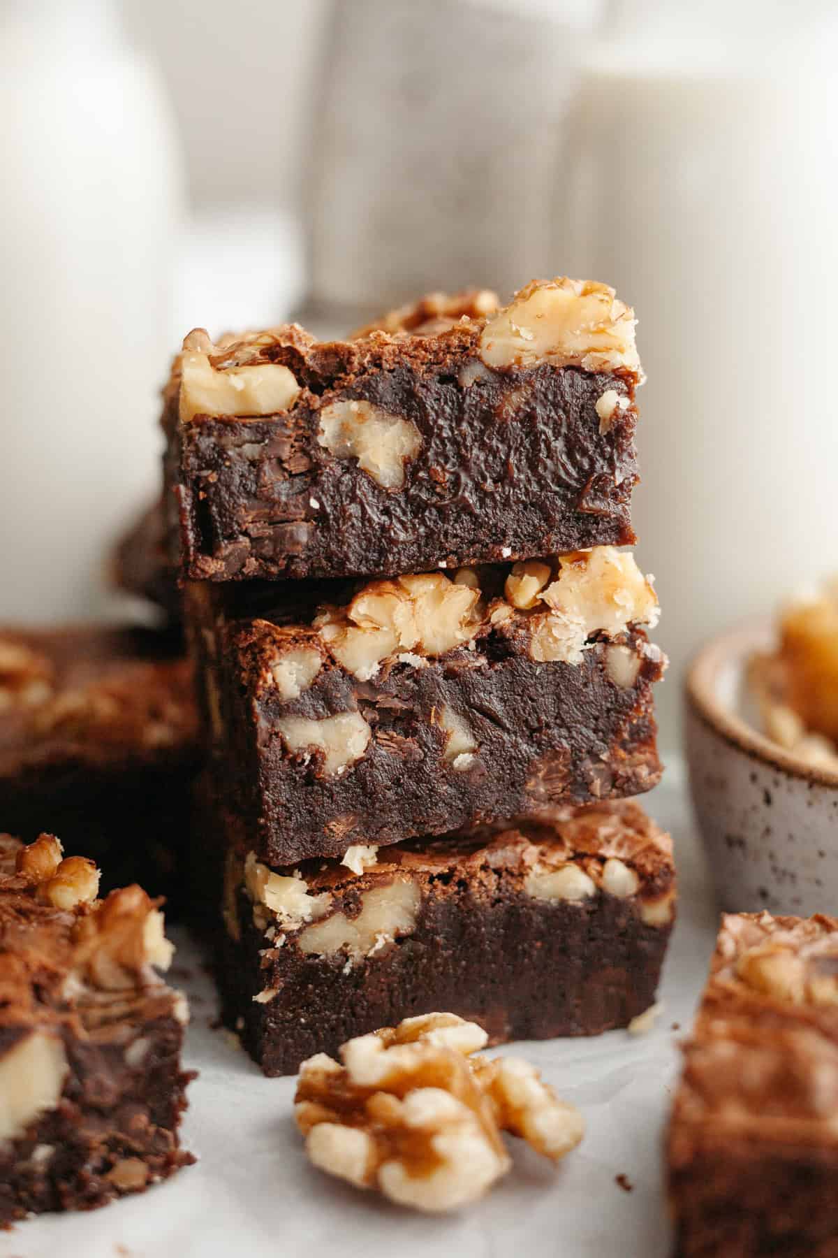 A stack of three fudgy walnut brownies.