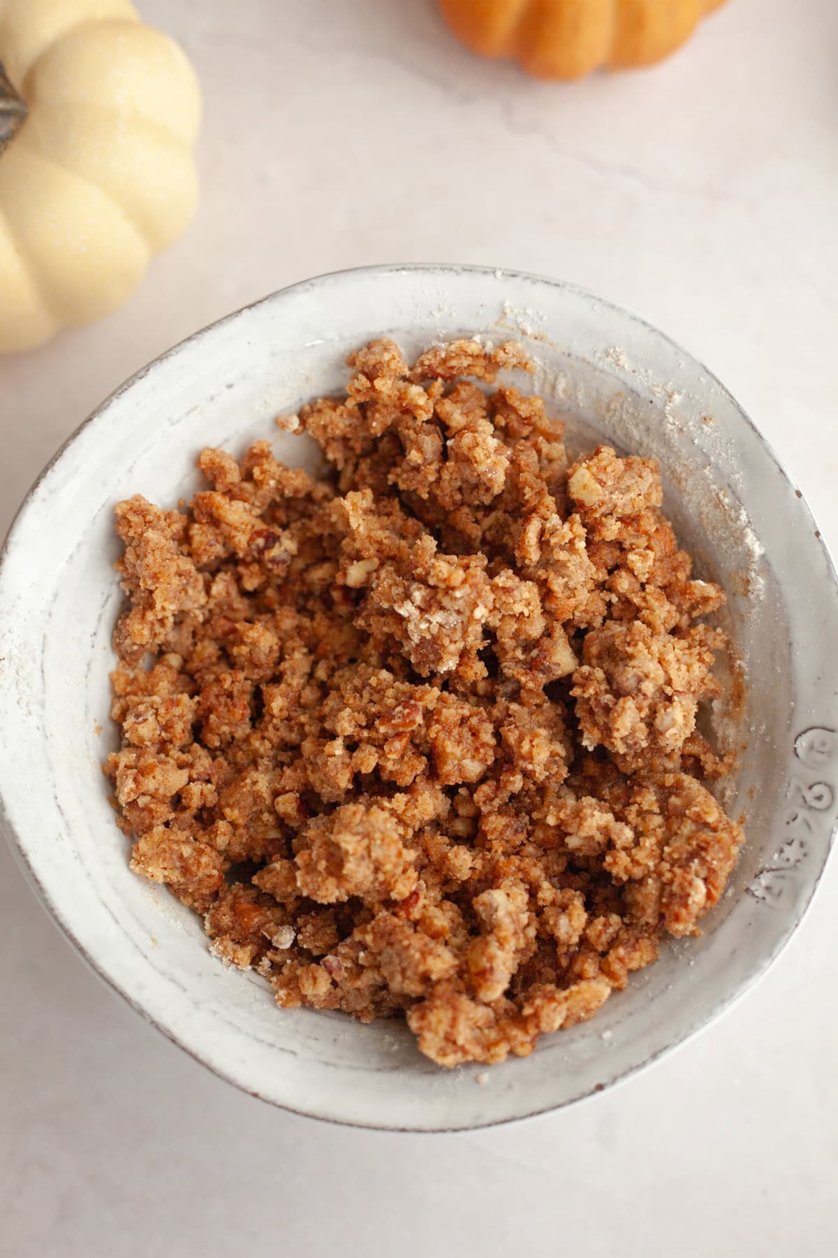 Pecan streusel in a small white bowl.