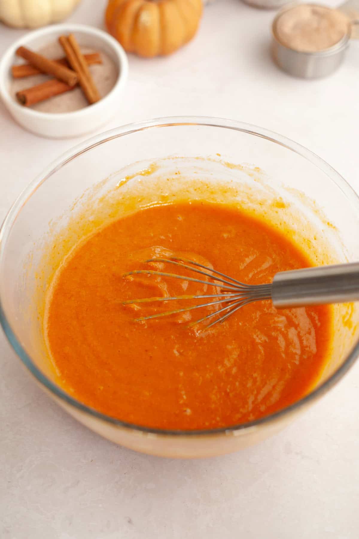 Pumpkin muffin batter in a glass bowl.