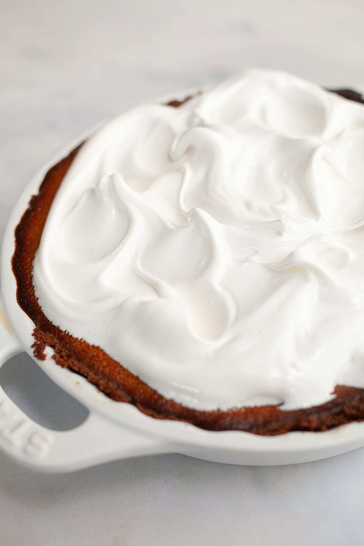 A pumpkin pie covered in marshmallow meringue.