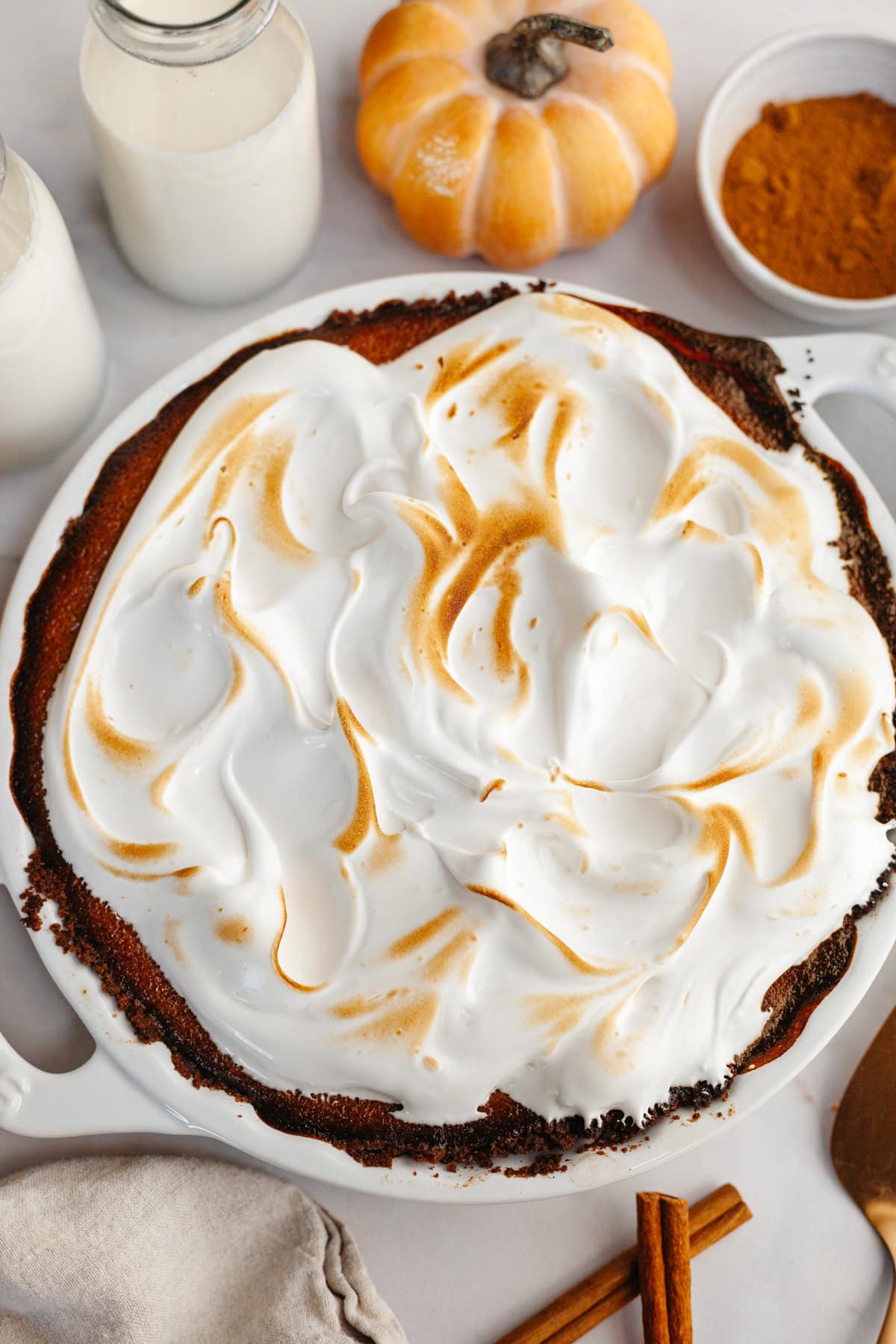 An overhead shot of a pumpkin pie covered in toasted marshmallow meringue.