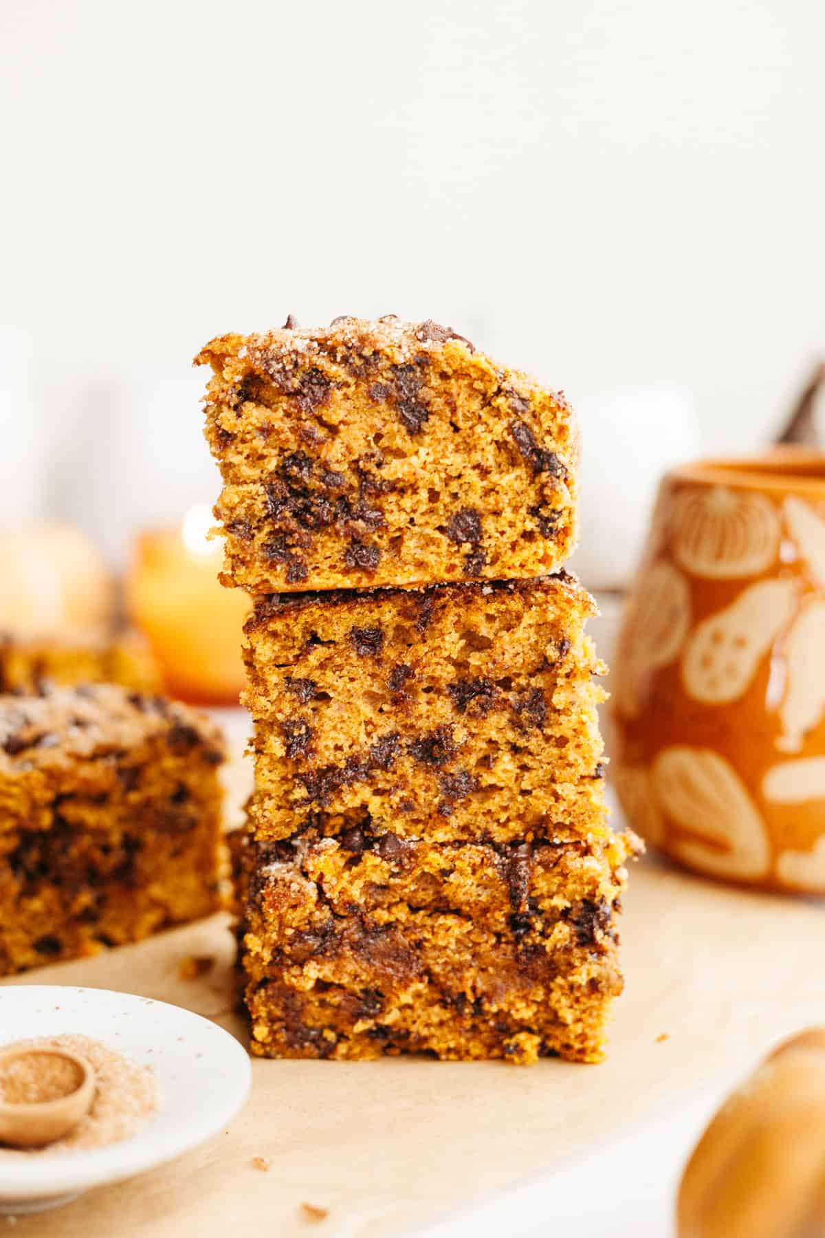 A stack of three slices of pumpkin chocolate chip cake.