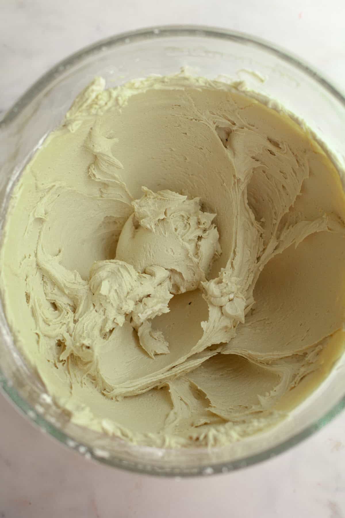 Pistachio frosting in a glass bowl.