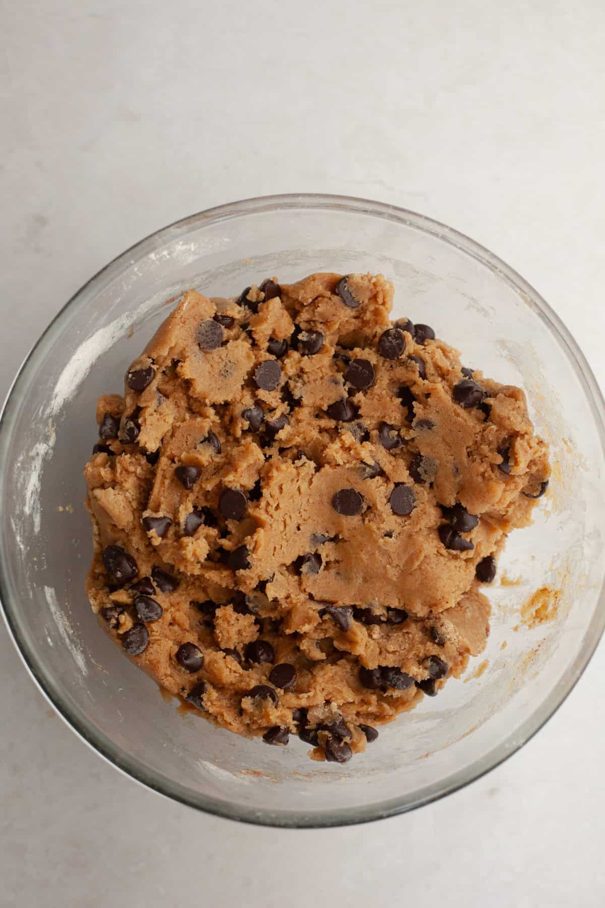 Chocolate chip cinnamon cookie dough in a glass bowl.