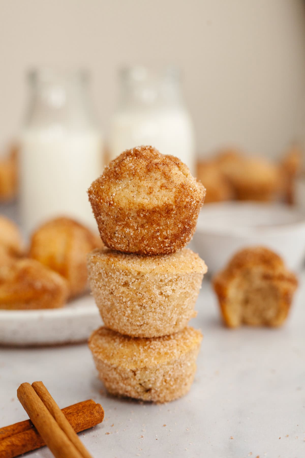 A stack of three cinnamon sugar mini muffins.