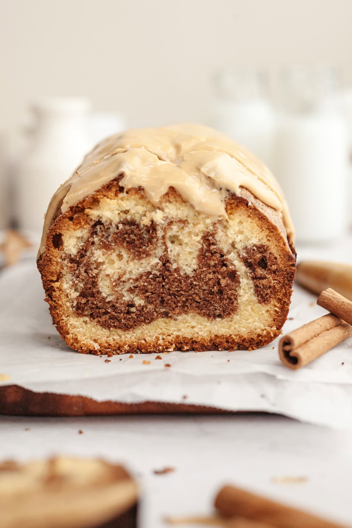 A cinnamon pound cake on parchment paper, sliced.