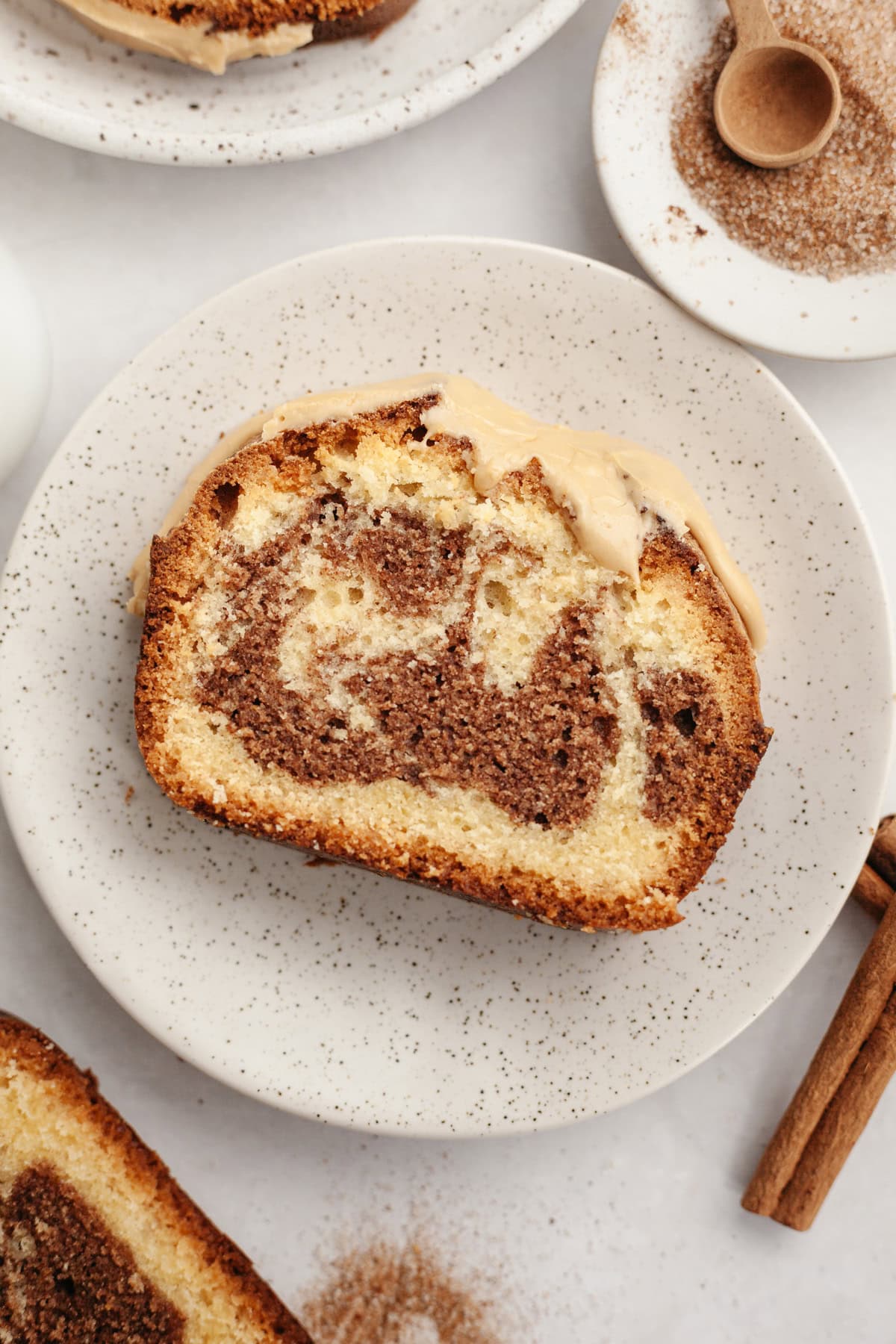 A slice of cinnamon pound cake on a small plate.