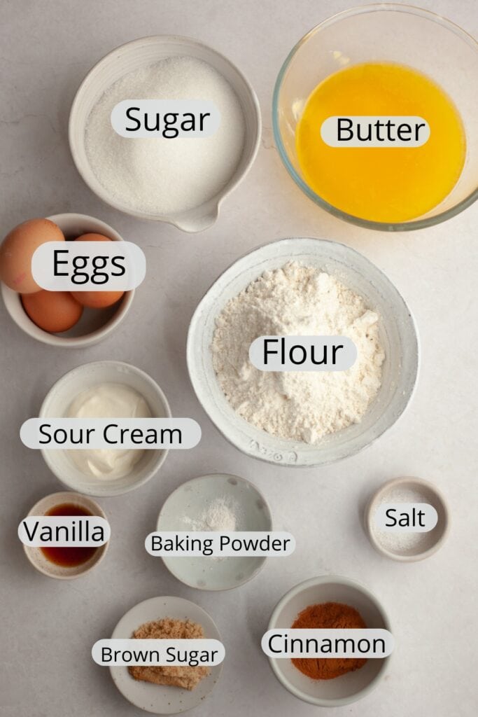 All the ingredients needed to make cinnamon pound cake, weighed out into small bowls.