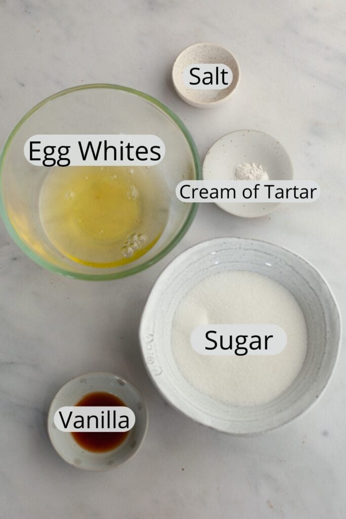 All the ingredients needed to make marshmallow meringue frosting, weighed out into small bowls.