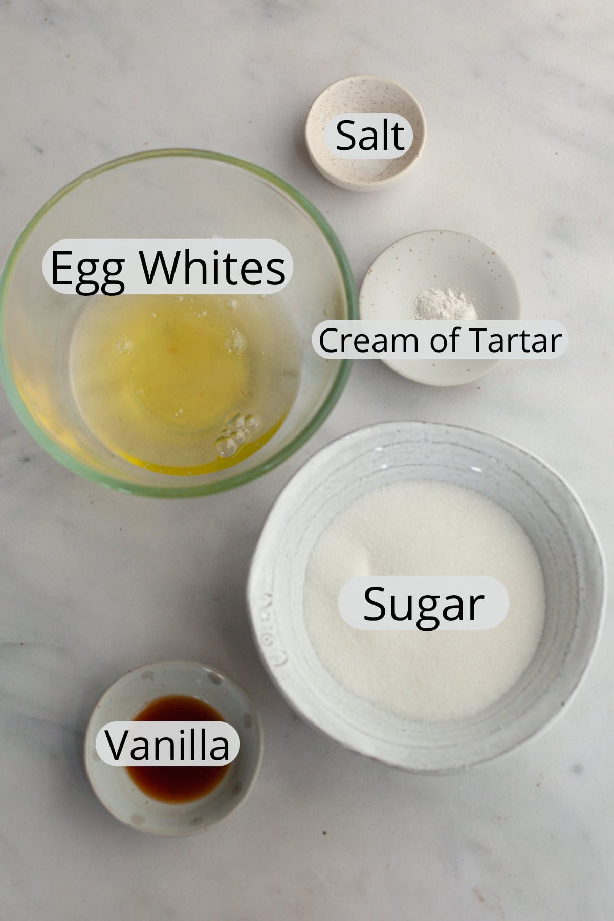 All the ingredients needed to make marshmallow meringue frosting, weighed out into small bowls.