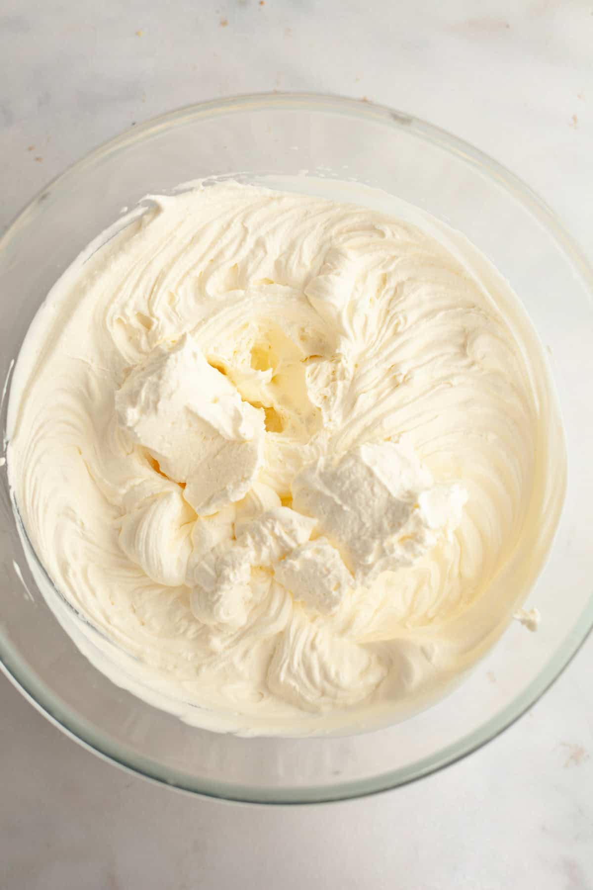 Whipped cream in a glass bowl.