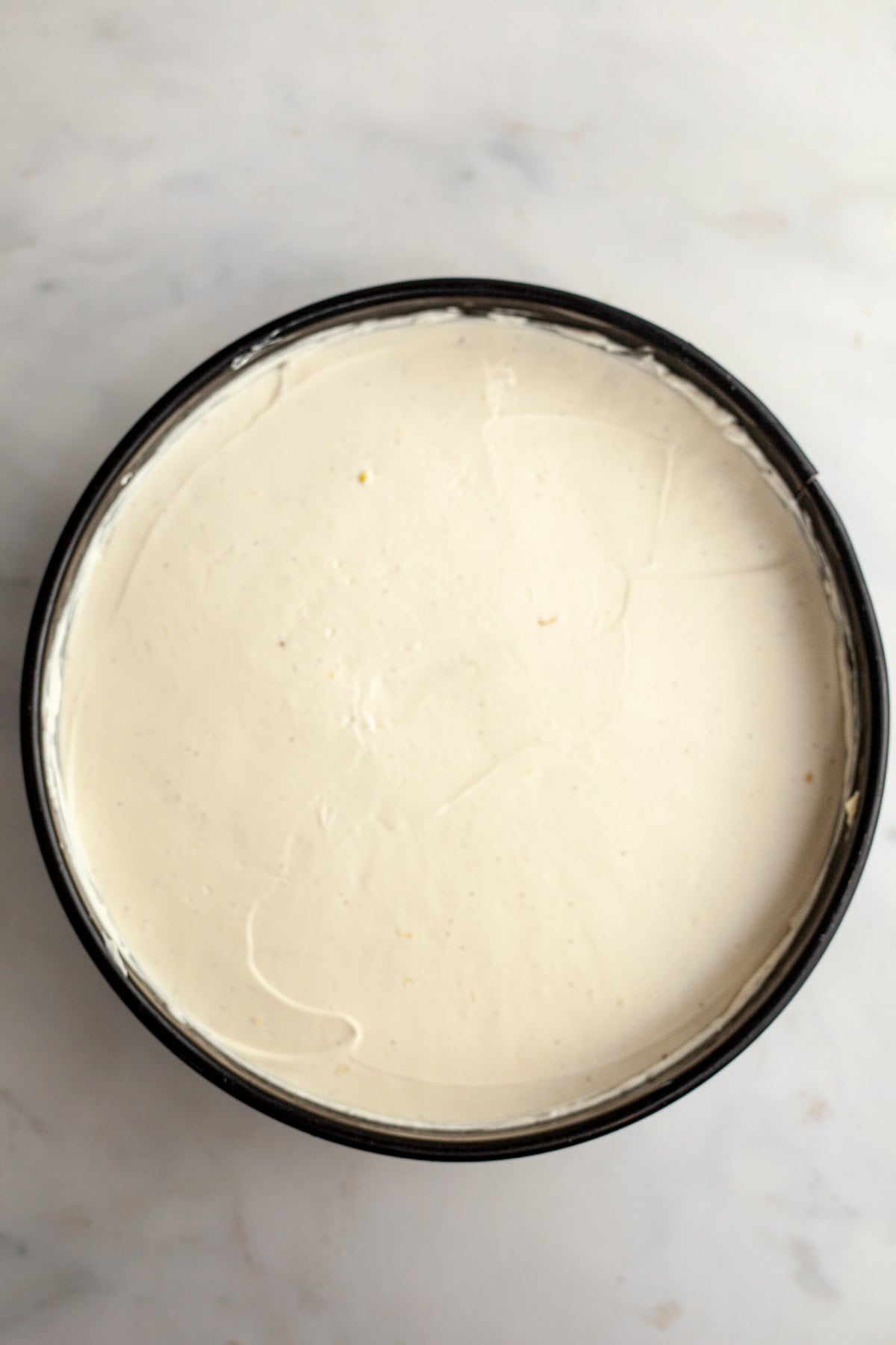 A cheesecake pan with a no bake vanilla cheesecake.