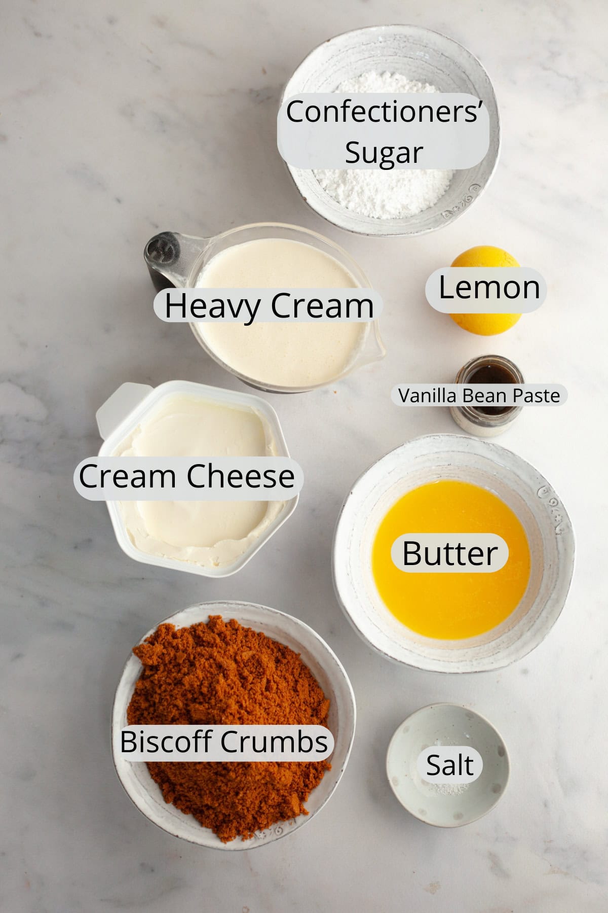 All the ingredients needed to make a no bake vanilla cheesecake, weighed out into small bowls.