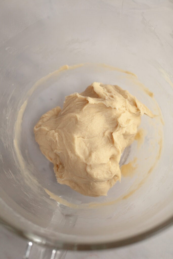 Cinnamon roll dough in a glass bowl.