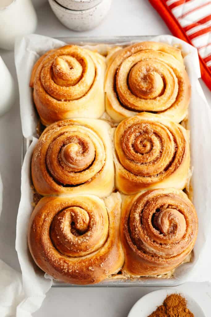 Six cinnamon buns in a small pan.