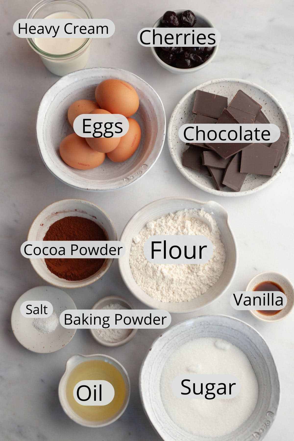 All the ingredients needed to make a black forest yule log, weighed out into small bowls.