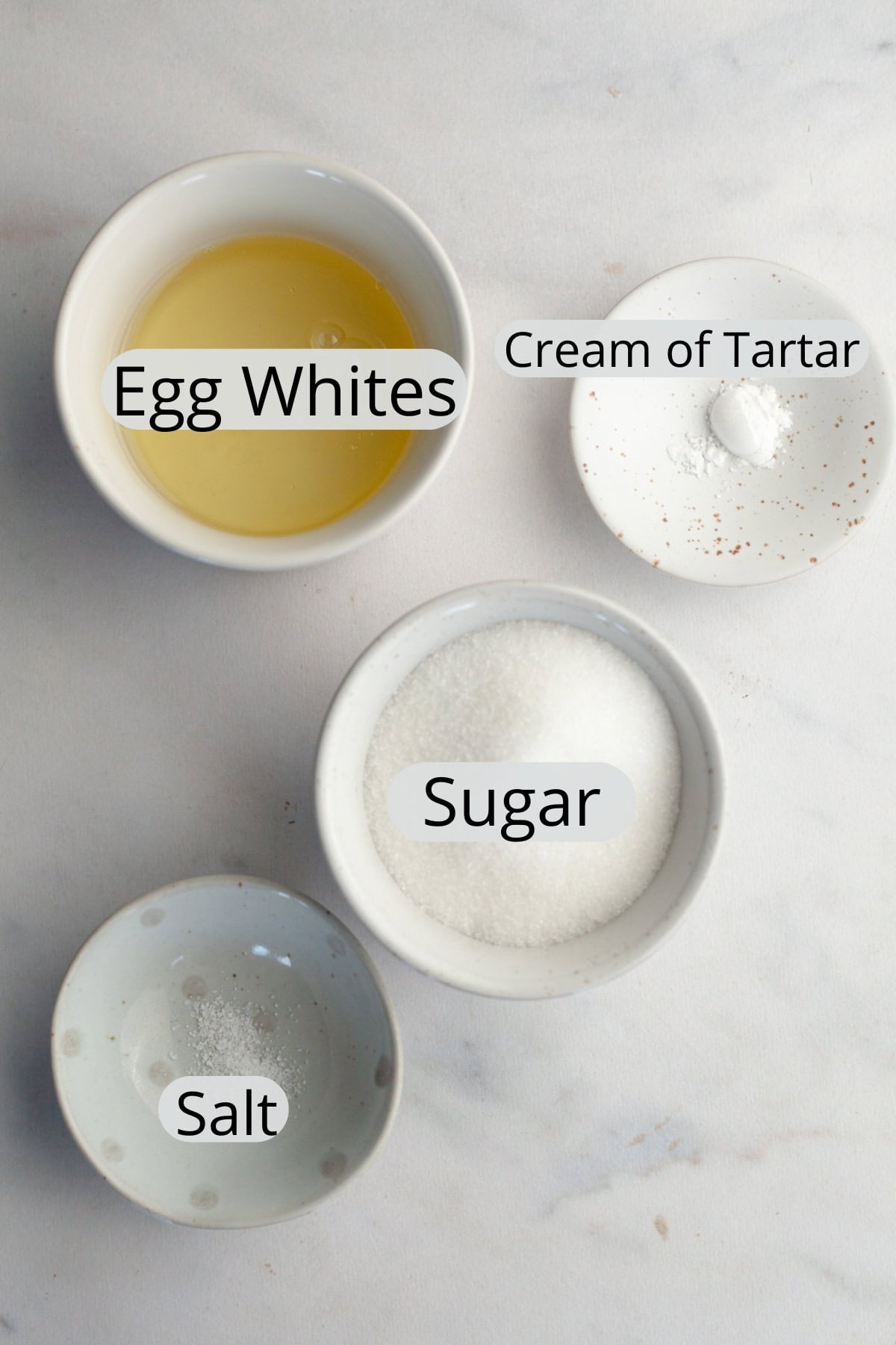 The ingredients needed to make meringue mushrooms, weighed out into small bowls.