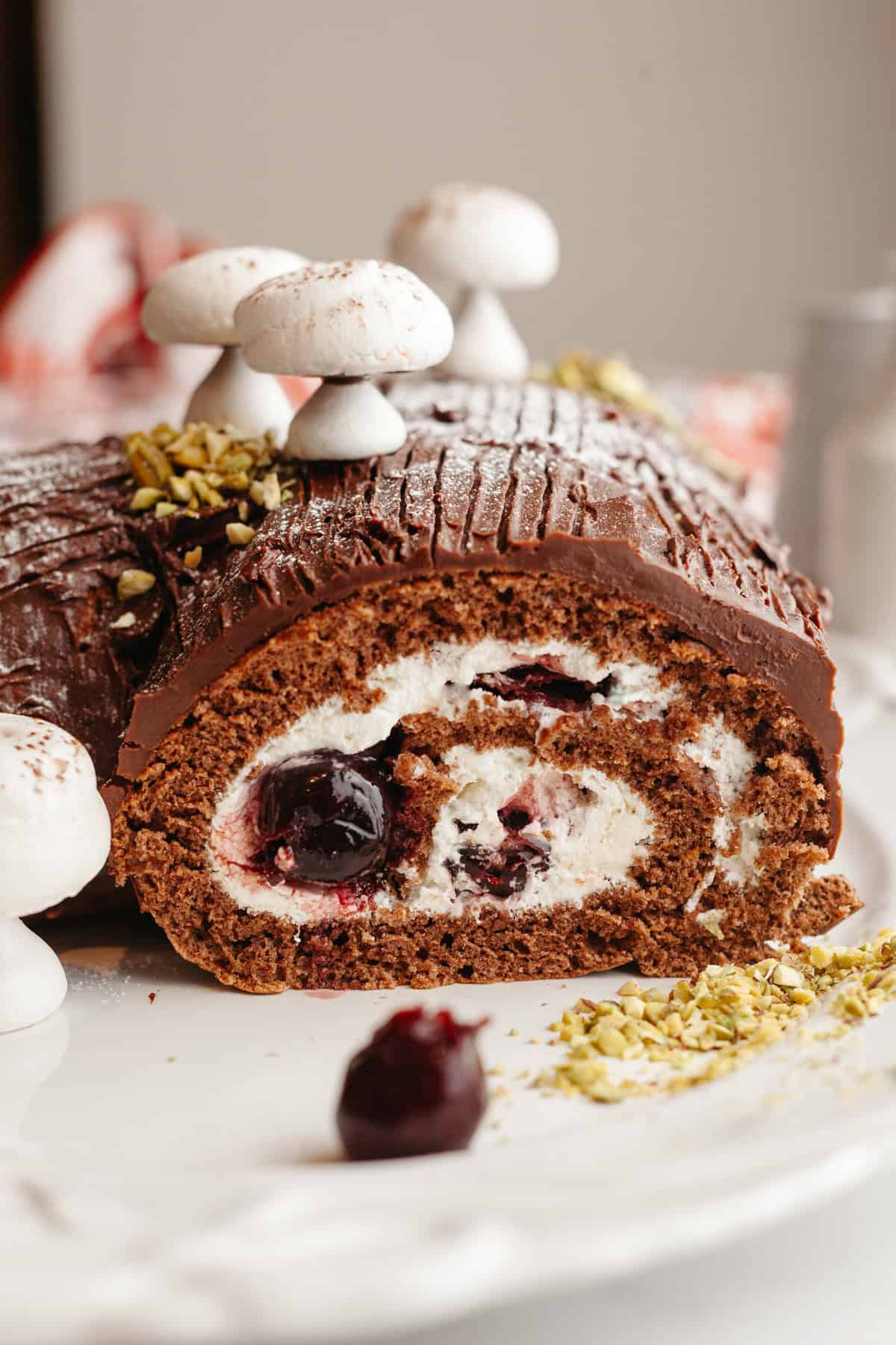A chocolate yule log with cream filling topped with meringue mushrooms.