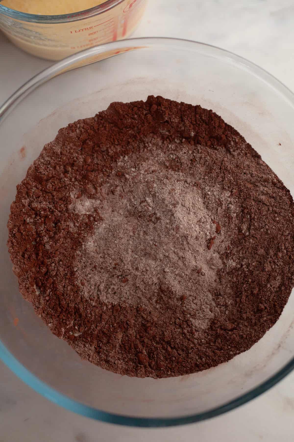 Flour and cocoa powder in a glass bowl.