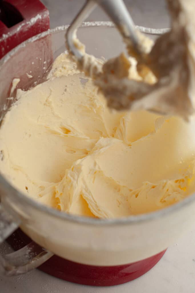 A glass bowl with buttercream in it.