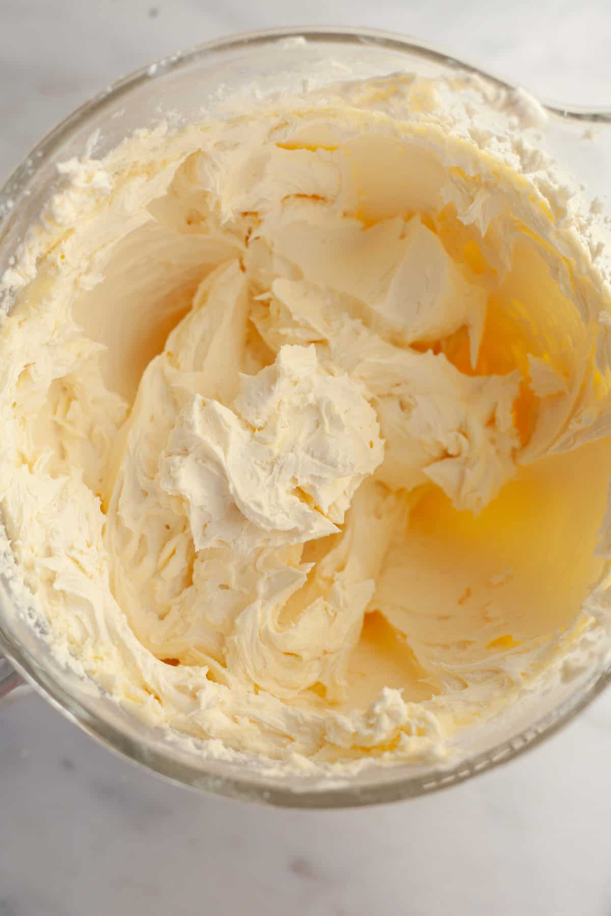 White frosting in a glass bowl.