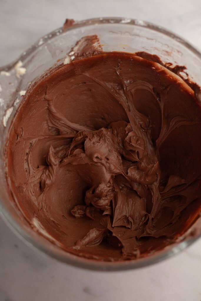 Mocha frosting in a glass bowl.