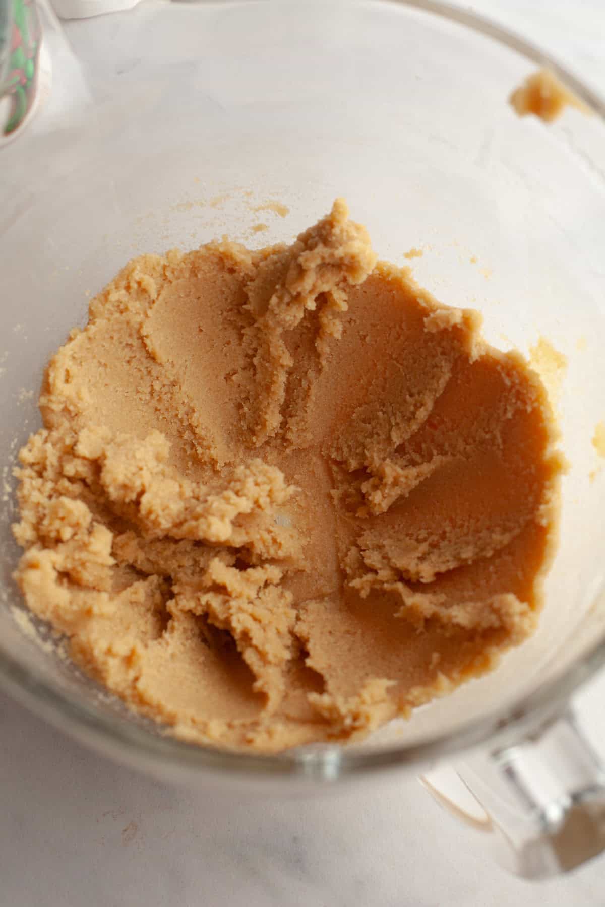 Creamed butter and sugar in a glass bowl.