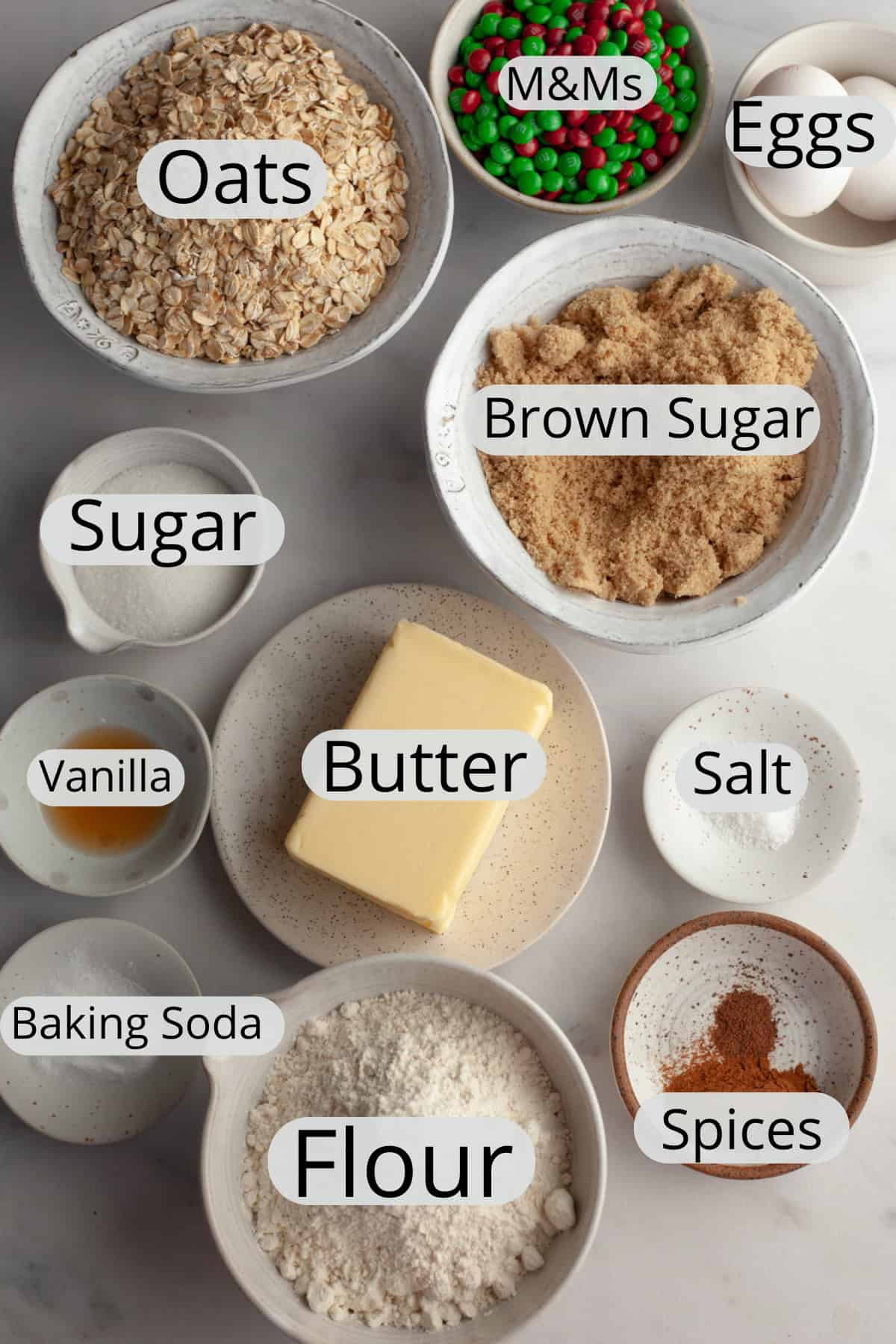All the ingredients needed to make Christmas oatmeal cookies, weighed out into small bowls.