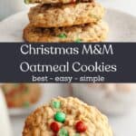 A hand holding a Christmas oatmeal cookie and a stack of oatmeal cookies on a plate.