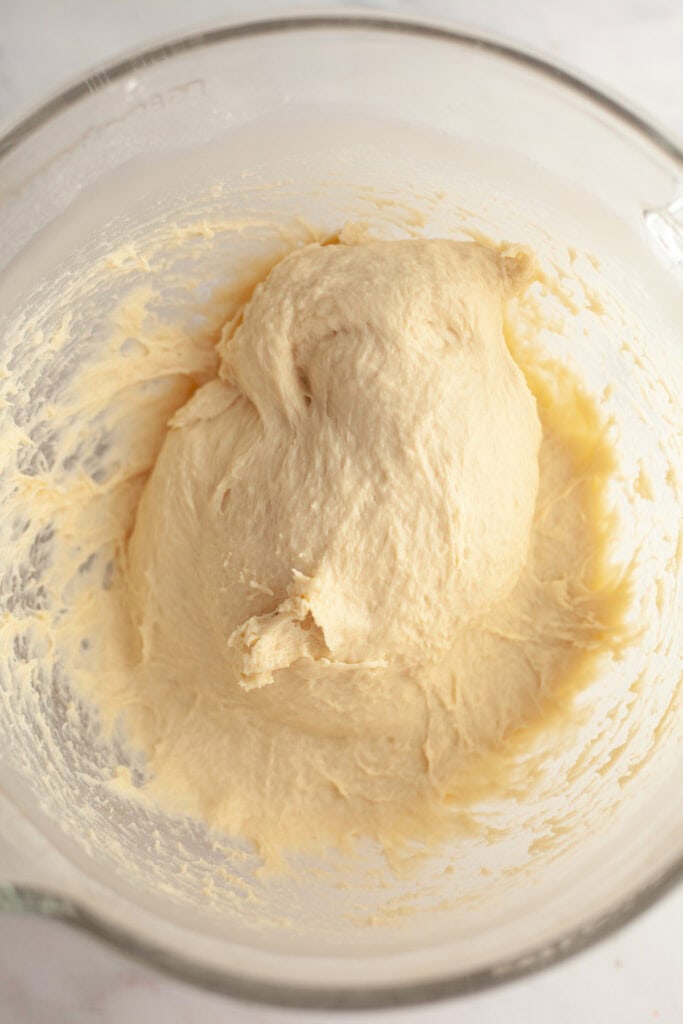 Cinnamon roll dough in a glass bowl.