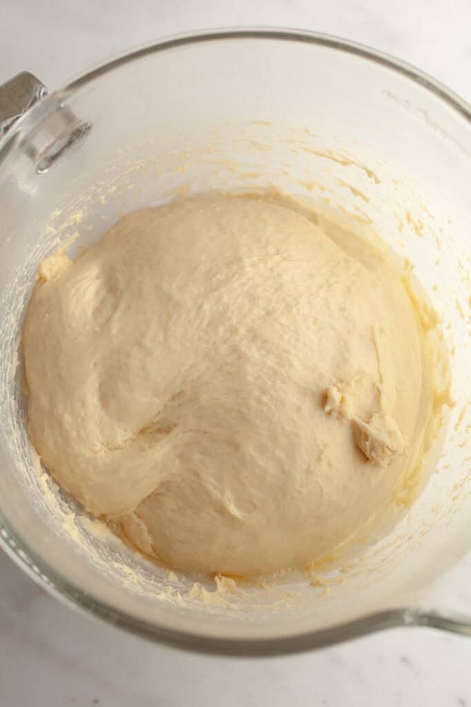 Cinnamon roll dough in a glass bowl.