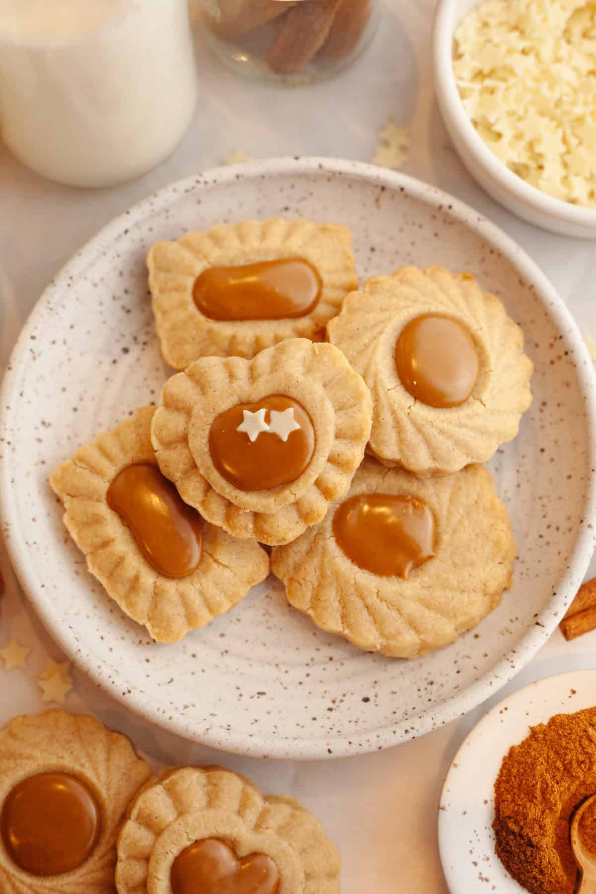 A small plate full with cinnamon shortbread cookies with a Biscoff middle.